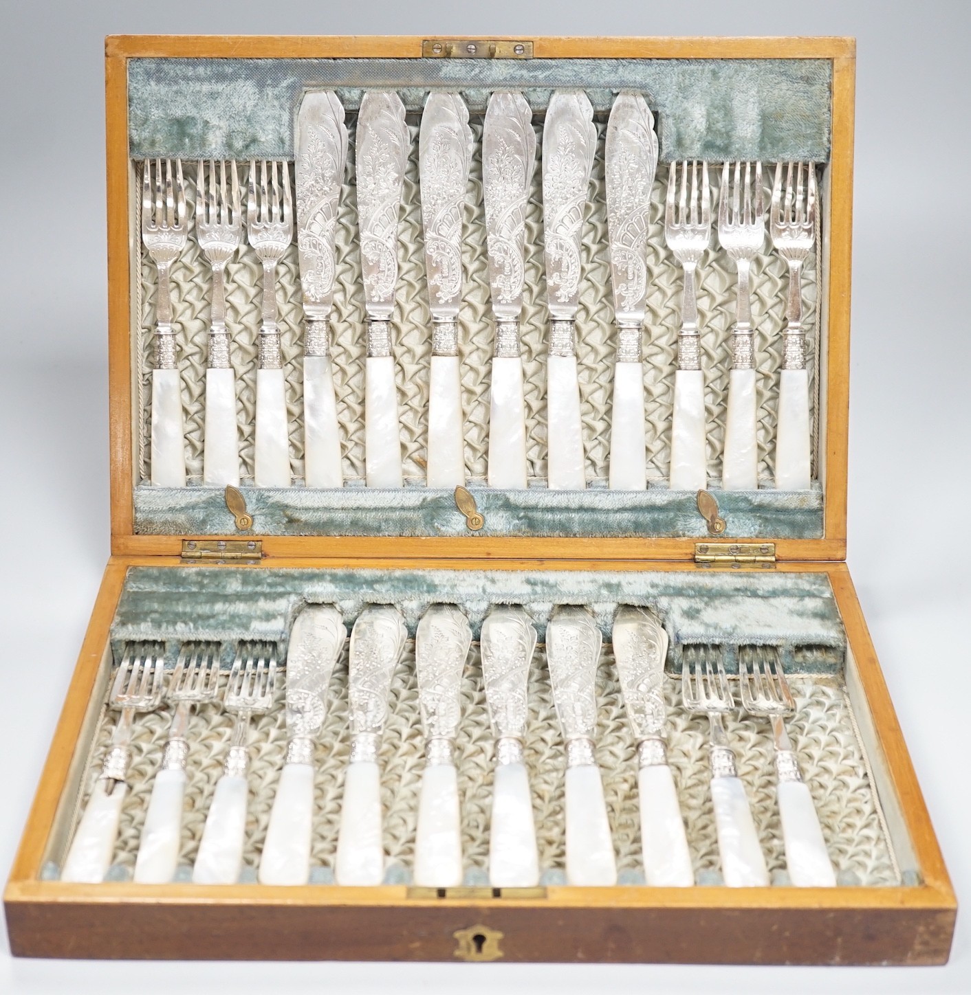 A cased set of twelve pairs of Victorian mother of pearl handed silver fish eaters (fork missing) R.F. Mosley & Co, Sheffield, 1894/1895 and a later cased set of twelve pairs of silver handled dessert eaters.